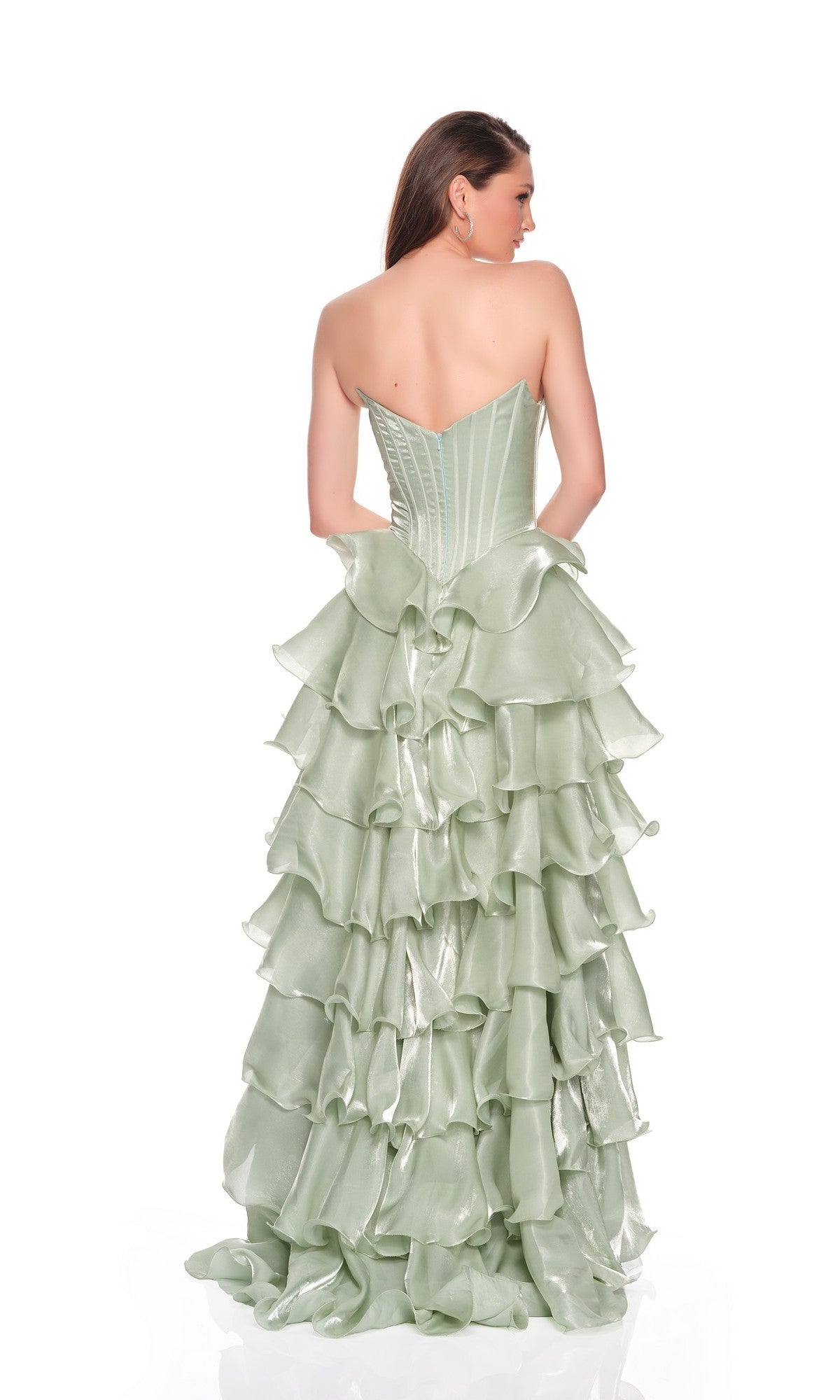 A woman faces away, wearing the Long Prom Dress: Dave and Johnny 12777—a strapless green gown with a fitted corset bodice and cascading organza ruffle tiers on its pale skirt.